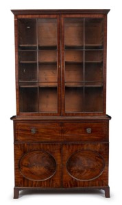 A handsome Georgian two door library bookcase in the Hepplewhite style, mahogany with ebony string inlay and oval recessed panel doors, late 18th century, 243cm high, 129cm wide, 57cm deep