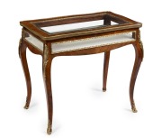 A fine antique English bijouterie table in the French style, rosewood veneer with fine ormolu mounts and beveled plate glass, late 19th century, 74cm high, 81cm wide, 50cm deep