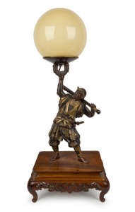 A stunning Japanese bronze samurai figural lamp with spherical glass shade, mounted on a wooden base, 71cm high