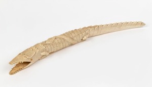 An African carved ivory crocodile and snake ornament, early to mid 20th century, 52cm long
