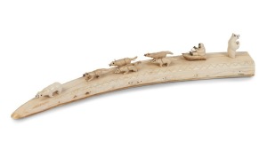 A walrus marine ivory ornament with dog sled and polar bears, engraved "ALOWA, R. SAVOONGA, A.K.", 47cm long