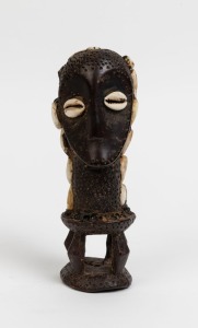 A tribal statue, carved ivory, shell and clay, African origin, 20cm high