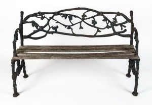 An antique English cast iron garden seat with timber slats, 19th/20th century, 126cm across the arms