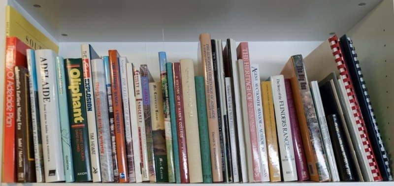 SOUTH AUSTRALIAN INTEREST: A shelf of books from the Bonython Family Library, including "Lake Eyre, South Australia : The Great Flooding of 1949-50" [with dedication, 1955], "History of the families of Bonython of Bonython and Bonython of Carclew...." by