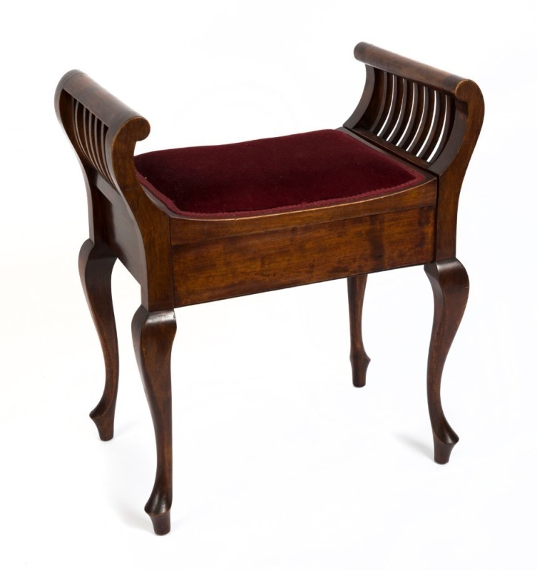 An Australian blackwood piano seat with lift-top upholstered sheet box and curved slats, circa 1920, 69.5cm high, 61.5cm wide, 38cm deep