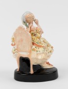 GOLDSCHEIDER Austrian porcelain statue of a seated lady in yellow dress, circa 1918, black factory mark "Goldscheider, Wien", with artist monogram "A. M.", 21cm high - 2