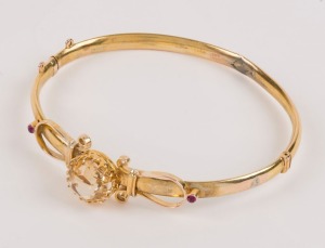 An antique 9ct gold bangle, set with citrine and rubies, 19th/20th century, 6cm wide, 6.6 grams total