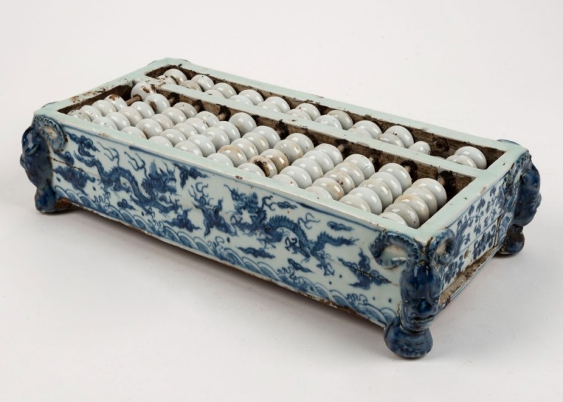 A Chinese porcelain table abacus, 19th/20th century, 9cm high, 37cm wide, 18cm deep