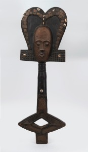 A tribal totem, carved wood, copper and shell with painted finish, African origin, 85cm high