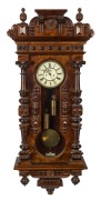 An impressive antique Vienna regulator wall clock with&nbsp;walnut veneered case, turned column decoration, eight day time and strike weight driven movement, and Roman numerals, 19th century, 140cm high