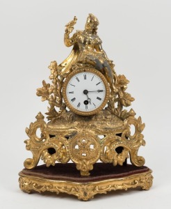 An antique French figural marble clock in gilt metal case, timepiece only with Roman numerals and original gilt timber stand, 19th century,  ​​​​​​​36cm high