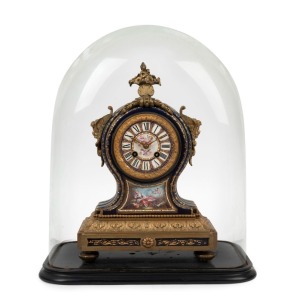 An antique French mantle clock with blue Sevres porcelain case ornately mounted in ormolu with eight day time and strike movement and Roman numerals.  Housed in original glass dome with ebonised timber base, 19th century, the clock 34cm high, the dome 43c