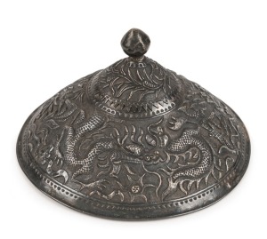 An antique Vietnamese silver conical shaped military hat badge, decorated with dragons, insects, birds and human figures, 19th century, ​​​​​​​7cm high, 11.5cm diameter