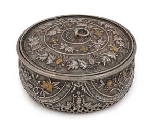 An antique Vietnamese silver circular box with pierced work base and gilt highlights, 19th century. The side walls decorated with highly chased works divided into four semi-circular panels with flowers of the four seasons, separated by four bats (symbol o