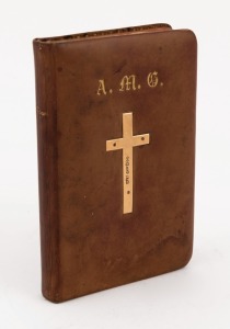 BOOK OF COMMON PRAYER pocket edition with brown calf skin boards and applied 15ct solid gold cross and family monogram. Family inscription on the end papers dated 1893. 11.5cm high