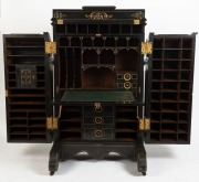 An impressive antique American Wooton desk, ebonized mahogany with incised gilt decoration and fitted panels throughout, 19th century. Opening to reveal numerous shelves and pigeonholes, with fall-front writing surface supported with mechanical metal brac - 2