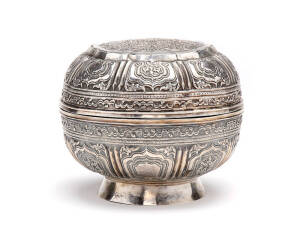 ASIAN SILVER: Bowl & cover. Top embossed with a central lattice-work panel within an eight-lobed foliated surround, sides embossed with 8 stylized lotus leaf panels. Early 20th century. Height 14cm, diameter 17cm, weight 600 grams.