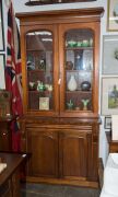 An Australian cedar bookcase with a cavetto pediment, two arch-top glazed doors, conforming lower panelled doors, an ogee-moulded drawer and carved corbels, 19th century, 235cm high, 114cm wide, 44cm deep - 3