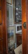 An Australian cedar bookcase with a cavetto pediment, two arch-top glazed doors, conforming lower panelled doors, an ogee-moulded drawer and carved corbels, 19th century, 235cm high, 114cm wide, 44cm deep - 8