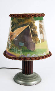 Vintage table lamp with revolving hand painted celluloid shade with hunting scene. 40cm