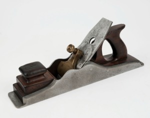 An impressive in-fill antique English wood plane by Buck of Tottenham Court Road, London, 19th century, together with three associated postcards. (4 items), sole 7cm wide, 39cm long