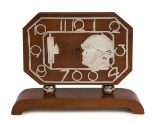 An Art Deco walnut mantle clock with chromed Arabic numerals and military profile portrait, circa 1930, 22cm high, 29cm wide