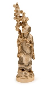 An antique Japanese carved ivory okimono, Meiji period, 19th/20th century, 24cm high
