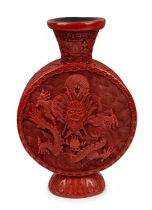 An antique Chinese cinnabar lacquer moon flask vase with dragon decoration, Qing Dynasty, 19th century, inscription to base, 27cm high