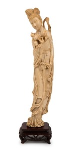 An antique Chinese carved ivory Guanyin statue on carved wooden base, Qing Dynasty, 19th/20th century, 34cm high