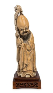 A Chinese carved ivory statue of a sage with staff and peach, done in the Ming style, 19th/20th century, seal mark to base, ​​​​​​​26.5cm high including stand