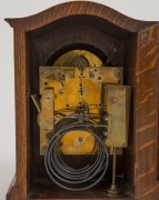 An antique German spring driven table clock in oak case, 8 day three train movement with quarter chiming on a nest of four coiled gongs, circa 1900, 23cm high - 2