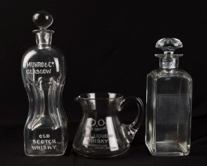 Two antique whisky advertising decanters and a water jug, 19th century, (3 items), the largest 31cm high