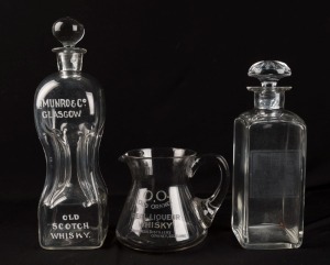 Two antique whisky advertising decanters and a water jug, 19th century, (3 items), ​​​​​​​the largest 31cm high