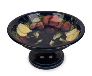 MOORCROFT "Wisteria" English pottery comport on blue ground, impressed "Moorcroft, Made in England" with blue underglaze signature, 11cm high, 20.5cm diameter