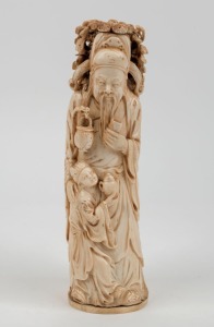 An antique Chinese carved ivory statue of a man with and a young boy, 19th/20th century, seal mark to base, 21.5cm high