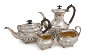 An antique English sterling silver four piece tea service with engraved armorial crest, made in London, circa 1865, the coffee pot 23.5cm high, 1845 grams total (including handles)