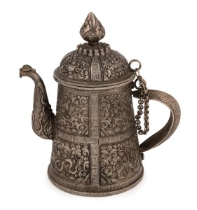 A Bhutanese silver teapot with finely chased decoration, 19th century, 17cm high, 410 grams