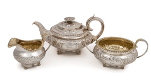 A Georgian three piece sterling silver tea service with engraved and repousse floral decoration, made in London, circa 1821, ​​​​​​​the teapot 15cm high, 27cm wide, 1200 grams total