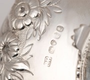 A Georgian three piece sterling silver tea service with engraved and repousse floral decoration, made in London, circa 1821, ​​​​​​​the teapot 15cm high, 27cm wide, 1200 grams total - 5