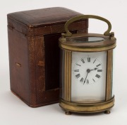 An antique French oval case carriage clock in original leather travel case, 19th century, ​​​​​​​15cm high overall - 2