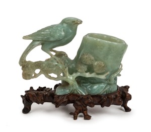 An antique Chinese carved jade brush washer, on carved wooden stand, Qing Dynasty, 19th century, 14.5cm high, 16cm wide
