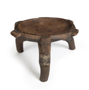 A ceremonial chair carved wood with old metal repairs, Arusha tribe, Tanzania, 32cm high, 60cm wide