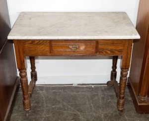 An antique oak washstand with marble top, late 19th century, (missing gallery, and wheels replaced), 78cm high x 91 cm wide x 52cm deep