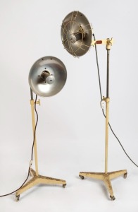 A pair of vintage industrial heat lamps, mid 20th century, ​​​​​​​170cm high each overall