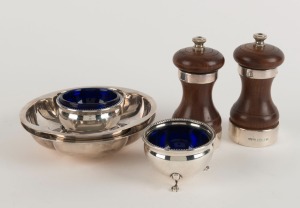 A pair of sterling silver dishes (215 grams total), a pair of sterling silver salt cellars (85 grams total), and a pair of sterling silver mounted pepper mills, 20th century, (6 items), the pepper mills10cm high, silver weight 300 grams total