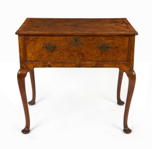 A George II English burr walnut lowboy, feather and cross banded top with fine return corners, single drawer with double cushion cross grain moulded edge, fine cabriole legs terminating on pad feet, mid 18th century, 71cm high, 76cm wide, 51cm deep