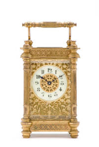 CARRIAGE CLOCK: A fine French 8 day clock with lever escapement. Beautifully decorated in pieced floral fretwork with a fluted column case. Late 19th to early 20th century (With key). 15cm