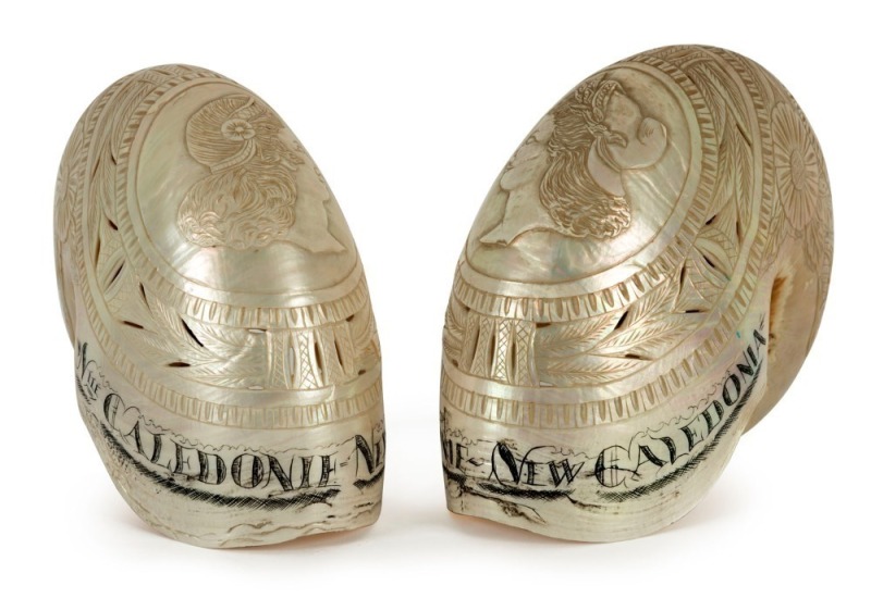 A fine pair of carved and engraved nautilus shells titled "NOUMEA, New Caledonia", the larger 12cm high, 15cm wide