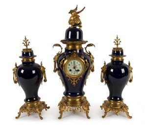 An antique French three piece blue porcelain clock set with ornate ormolu mounts, 8 day time and bell striking movement with Arabic numerals, 19th century, 60cm high