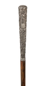 An antique walking stick with Indian silver handle, palm wood shaft and brass ferrule, 19th century, 90.5cm high